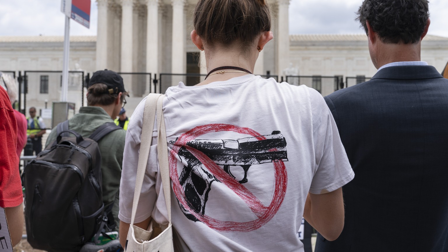 A woman wears an anti-gun T-shirt outside of the Supreme Court, following the Supreme Court&#039;s decision to overturn Roe v. Wade in Washington, Friday, June 24, 2022. The Supreme Court on Thursday  ...