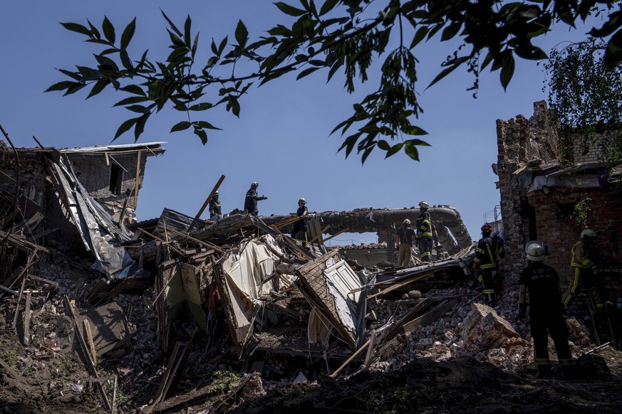 Rescue workers clearing rubble of destroyed house after a Russian attack on a residential neighborhood in downtown Kharkiv, Ukraine, on Saturday, July 9, 2022. (AP Photo/Evgeniy Maloletka)