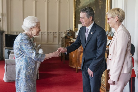 Britain&#039;s Queen Elizabeth II receives the President of Switzerland Ignazio Cassis and his wife Paola Cassis during an audience at Windsor Castle in Windsor, England, Thursday, April 28, 2022. (Do ...