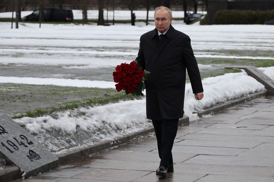 Russian President Vladimir Putin attends events marking the 80th anniversary of the break of Nazi's siege of Leningrad, (now St. Petersburg) during World War Two at the Piskaryovskoye Memorial Cemeter ...