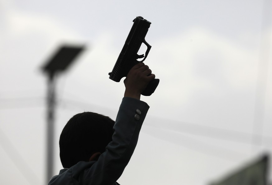 epa12232563 A Houthi supporter holds up a weapon during a protest against the United States and Israel, amidst the ongoing military campaign in the Gaza Strip, in Sana'a, Yemen, 11 July 2025. Hou ...