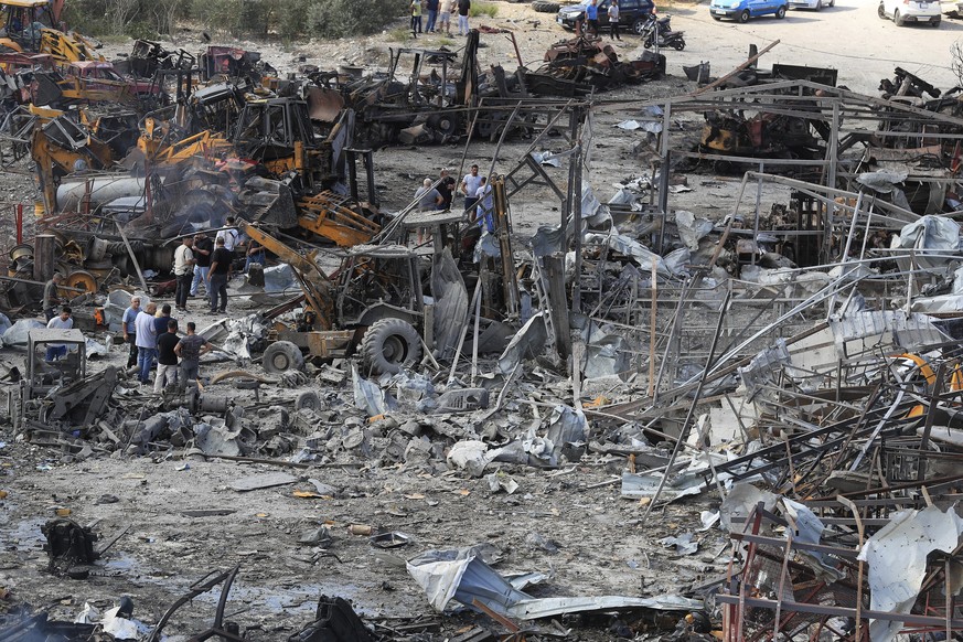 Lebanese people inspect the site where Israeli airstrikes on Wednesday night hit bulldozers in Ansariyeh village, south Lebanon, Thursday, Sept. 4, 2025. (AP Photo/Mohammed Zaatari)
Lebanon Israel