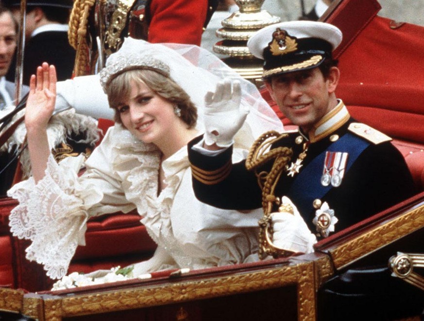 The Princess and Prince of Wales wave from their carriage on their wedding day, in this July 29, 1981 photo in London. (KEYSTONE/AP Photo/PA) UNITED KINGDOM OUT