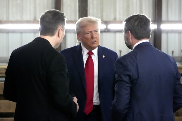 Republican presidential nominee former President Donald Trump, center, speaks with Tesla and SpaceX CEO Elon Musk, left, and Republican vice presidential nominee Sen. JD Vance, R-Ohio, at a campaign e ...