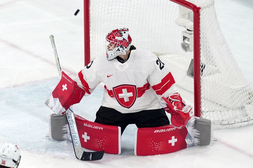 Switzerland goalkeeper Andrea Braendli blocks a shot against Sweden during the third period of the women's ice hockey bronze medal game at the 2026 Winter Olympics, in Milan, Italy, Thursday, Feb ...