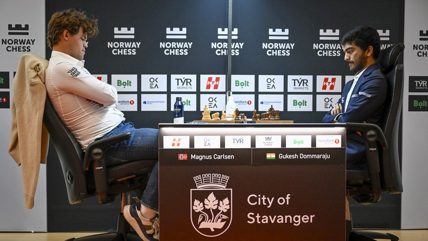epa12137190 Magnus Carlsen (L) from Norway and Gukesh Dommaraju from India compete in a match during the Norway Chess 2025 tournament at Finansparken in Stavanger, Norway, 26 May 2025. EPA/Carina Joha ...