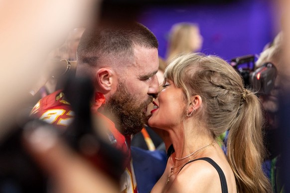 LAS VEGAS, NEVADA - FEBRUARY 11: Travis Kelce #87 of the Kansas City Chiefs and Taylor Swift kiss following the NFL Super Bowl 58 football game between the San Francisco 49ers and the Kansas City Chie ...