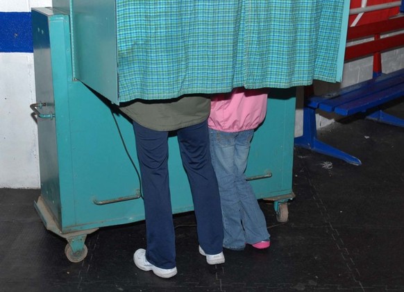Times Union staff photo by Lori Van Buren -- Janet Stoler, of Troy, votes while her granddaugher Violet, age 9, observes in a voting booth at the Frear Park Ice Rink in Troy, NY on November 6, 2007. F ...