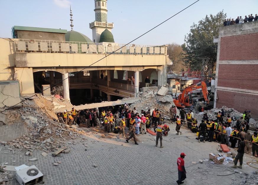 epa10439894 Rescue workers at the scene of a blast at a Mosque, in Peshawar, Pakistan, 30 January 2023. At least 28 worshippers were killed and dozens injured in a blast during prayers at a Mosque sit ...
