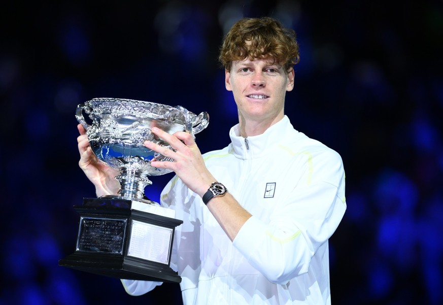 epa11854416 Jannik Sinner of Italy poses with the Norman Brookes Challenge Cup trophy after winning the Men's Singles final match against Alexander Zverev of Germany at the Australian Open Grand  ...