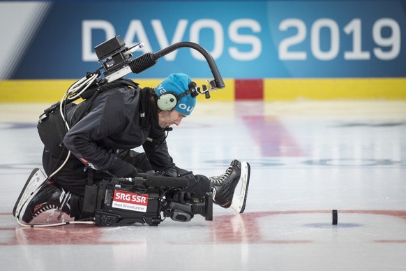 A camera man films the puck before the game between HC Ocelari Trinec and Team Canada, at the 93th Spengler Cup ice hockey tournament in Davos, Switzerland, Thursday, December 26, 2019. (KEYSTONE/Mela ...