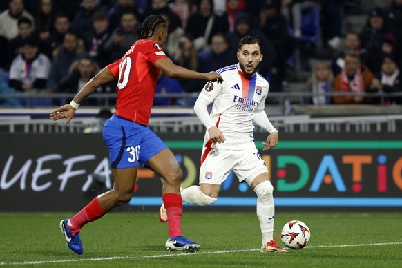 epa11962355 Rayan Cherki (R) of Lyon in action against Siyabonga Ngezana (L) of FCSB during the UEFA Europa League round of 16, 2nd leg soccer match between Olympique Lyonnais against FCSB, in Lyon, F ...