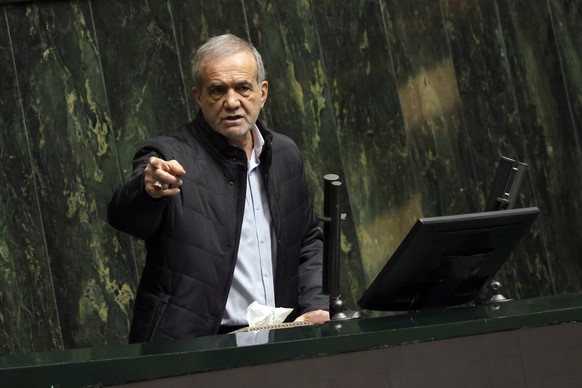 epa11934141 Iranian President Masoud Pezeshkian speaks during a Parliament session to defend his Minister of Economy and Finance at the Iranian Parliament in Tehran, Iran, 02 March 2025. According to  ...