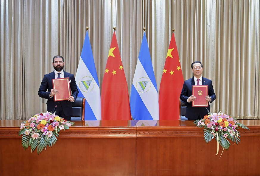 In this photo released by China&#039;s Xinhua News Agency, representatives from Nicaragua and China sign a joint communique on the resumption of diplomatic relations between the two countries in north ...