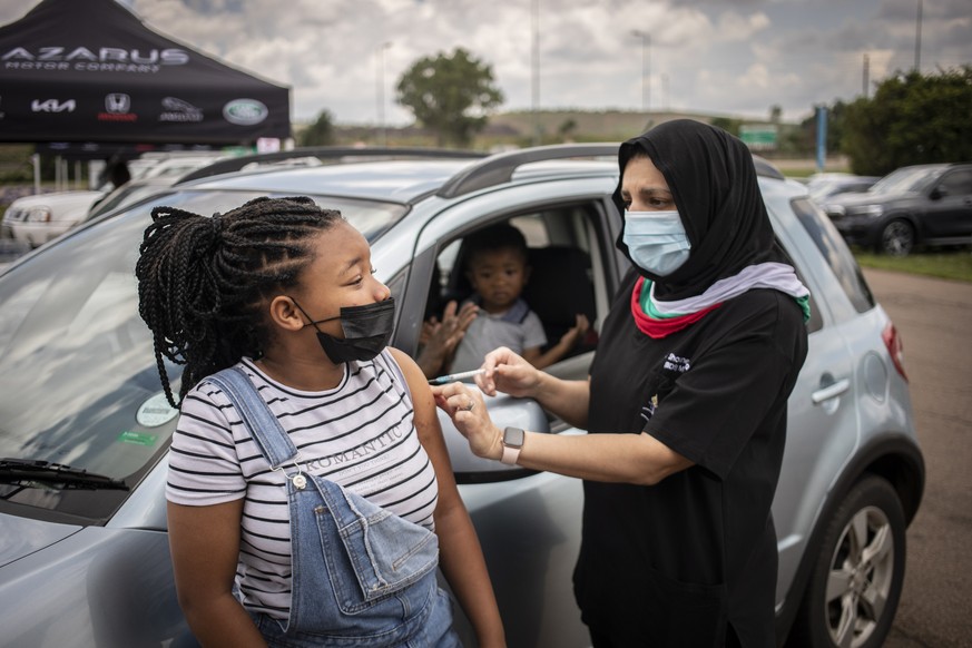 epa09642810 A teenager receives a jab of Covid-19 vaccine at a drive-through vaccination facility at the Zwartkops Raceway in Pretoria, South Africa, 15 December 2021. The facility opened in an effort ...