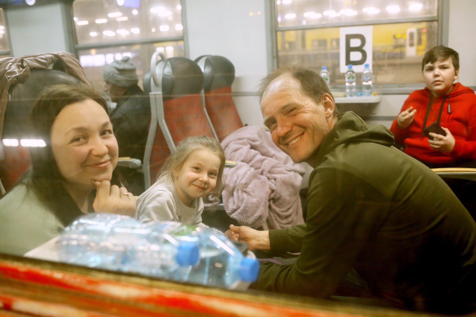 epa09834753 Refugees from Ukraine get into a passenger train heading to Germany at the train station in Katowice, south-west Poland, 18 March 2022. Over 2 million refugees have now crossed the Polish  ...