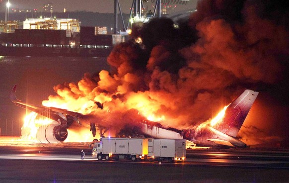 epa11053270 A Japan Airline (JAL) passenger plane bursts into flames on the tarmac at Haneda Airport in Tokyo, Japan, 02 January 2024, after its landing. The JAL airplane apparently collided with a Ja ...