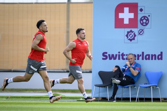 Switzerland's national soccer teams director Pierluigi Tami, right, looking at Switzerland's forward Noah Okafor, left, and Switzerland's midfielder Xherdan Shaqiri, center, running during a open trai ...