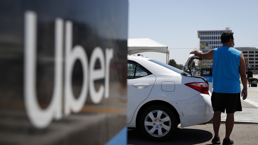 epa09395793 An Uber driver waits for passengers at the Los Angeles International Airport&#039;s LAX-it pick up terminal in Los Angeles, California, USA, 04 August 2021. The LAX-it pick up terminal was ...