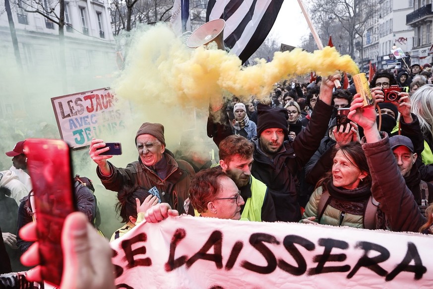 epa10547193 Protesters holding flares participate in a rally against the government&#039;s pension reform in Paris, France, 28 March 2023. France faces an ongoing national strike against the governmen ...