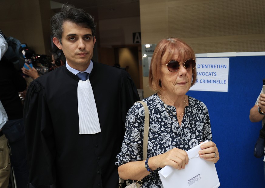 epa11609845 Gisele Pelicot (C), escorted by her lawyer Stephane Babonneau (L) exits under public aplause at the criminal court in Avignon, southern France, 17 September 2024, where her ex-husband stan ...