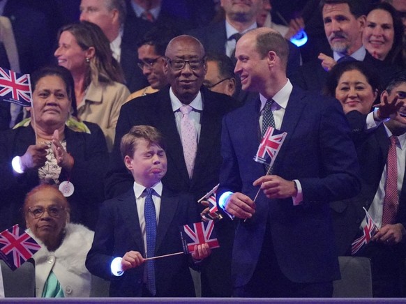 WINDSOR, ENGLAND - MAY 07: Prince George, and Prince William, Prince of Wales, in the Royal Box at the Coronation Concert in the grounds of Windsor Castle on May 7, 2023 in Windsor, England. The Winds ...