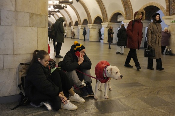 People rest in the subway station being used as a bomb shelter during a rocket attack in Kyiv, Ukraine, Thursday, Dec. 29, 2022. (AP Photo/Efrem Lukatsky)