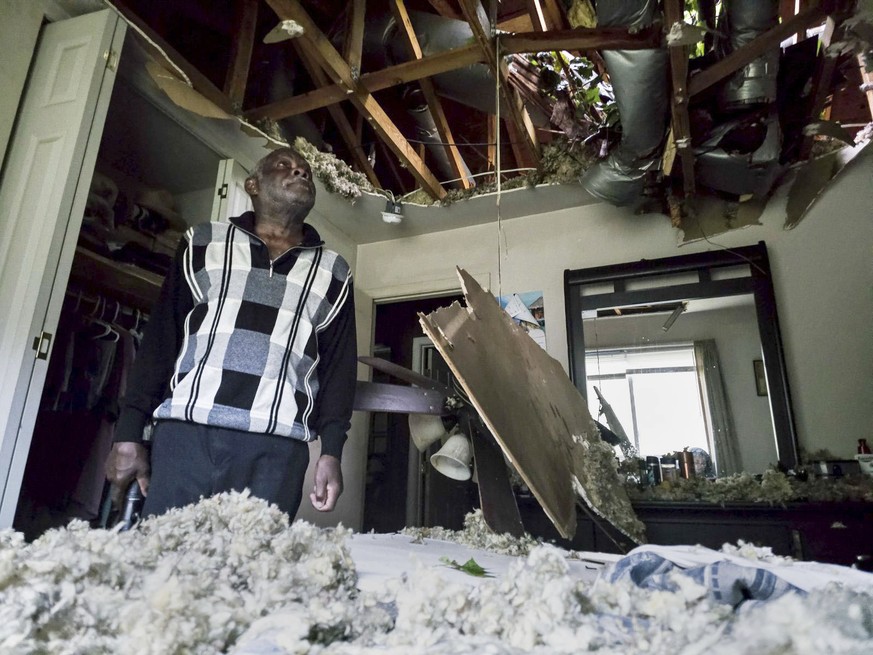McKinley Moore inspects the damage on his home after a tree fell over his bedroom after Hurricane Helen passed the area Friday, Sept. 27, 2024 in Charlotte, N.C. (Khadejeh Nikouyeh/The Charlotte Obser ...