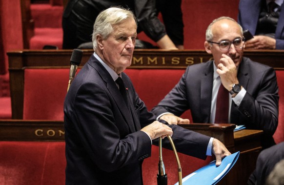 epa11741877 French Prime Minister Michel Barnier (L) arrives for a session of questions to the government at the French National Assembly, in Paris, France, 26 November 2024. The French National Assem ...