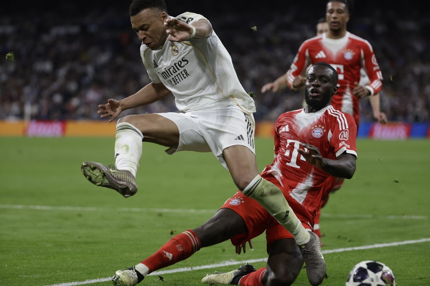 epa12874181 Real Madrid's Kylian Mbappe (L) in action against Bayern's Dayot Upamecano (R) during the UEFA Champions League quarter finals first leg soccer match between Real Madrid and Baye ...