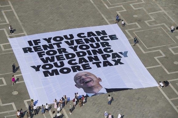 This photo released by Greenpeace shows a large banner against Amazon founder Jeff Bezos&#039; planned wedding, in St. Mark Square, in Venice, Italy Monday, June 23, 2025. (Greenpeace via AP)
Italy Be ...