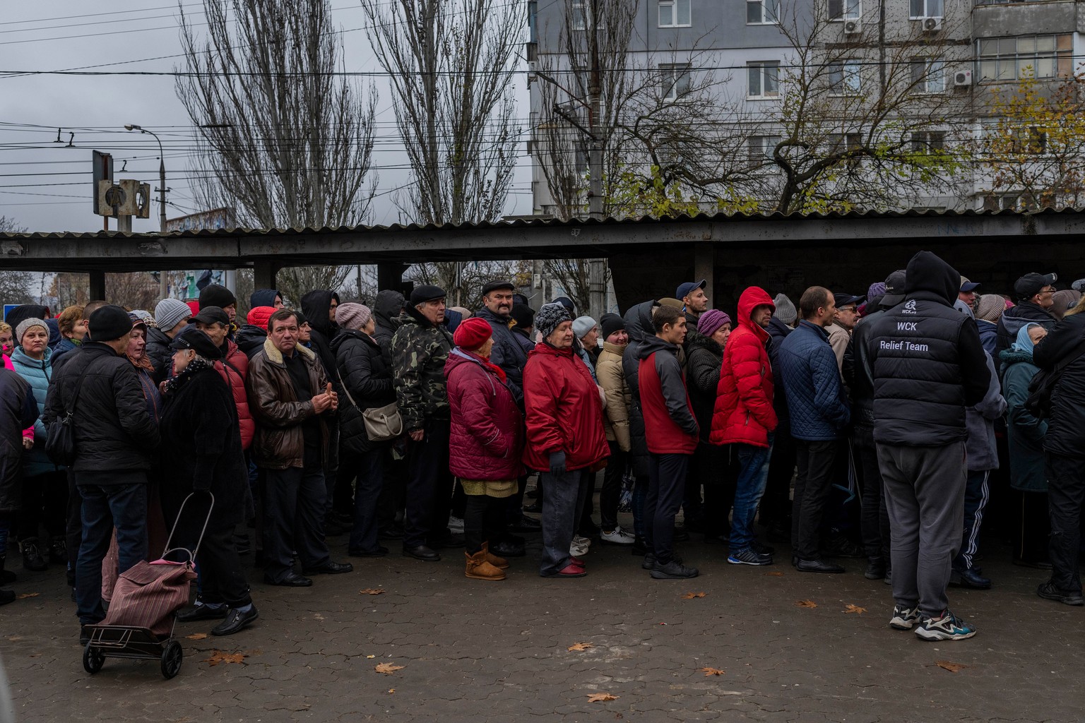 People queue to receive food donations in Kherson, in southern Ukraine, on Thursday, November 17, 2022. (AP Photo/Bernat Armangue)
