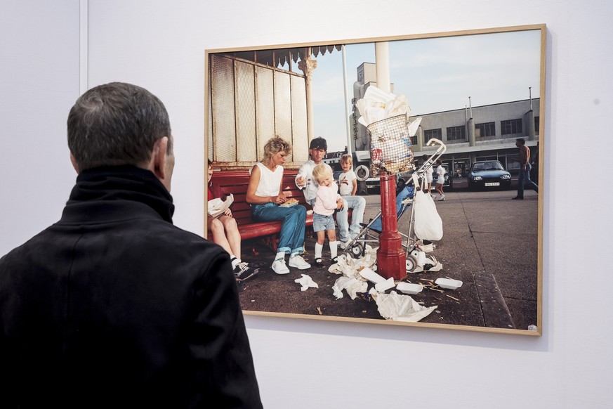 epa11705527 A man looks at a picture by British photographer Martin Parr exhibited during the Paris Photo fair at the Grand Palais in Paris, France, 06 November 2024. The 27th Paris Photo runs from 07 ...