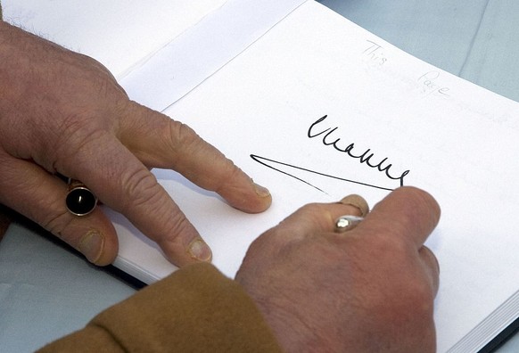 SOWERBY BRIDGE- NOVEMBER 24 : (NO PUBLICATION IN UK MEDIA FOR 28 DAYS) Prince Charles, Prince of Wales, President of the Prince&#039;s Regeneration Trust, signs the visitors book when he visits the So ...