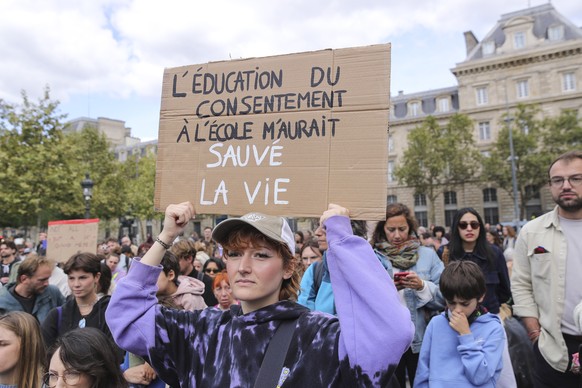 epa11603688 A woman carries a banner with the message &#039;Consent education at school would have saved my life&#039; during a feminist demonstration also in support of Gisele Pelicot, victim of alle ...
