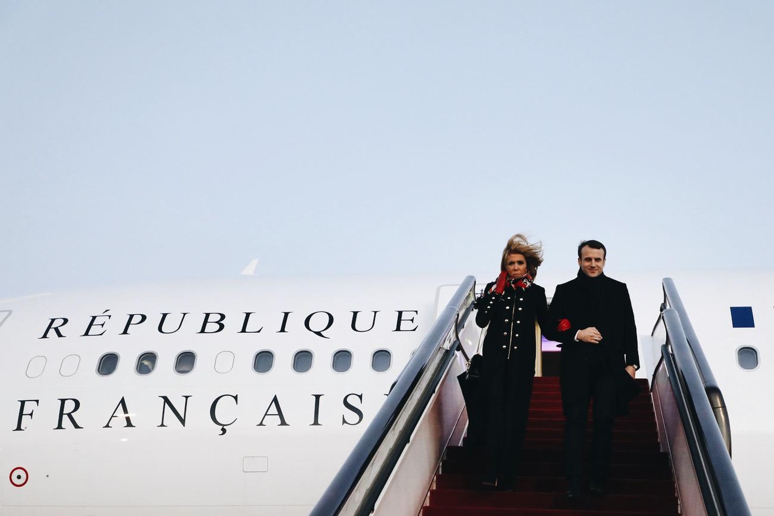 French President Emmanuel Macron and his wife Brigitte Macron arrive at Beijing&#039;s Capital Airport in Beijing Monday, Jan. 8, 2018. Macron says he will ask Chinese leaders to form a partnership to ...