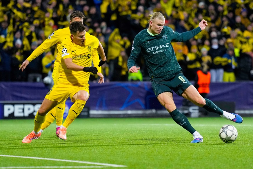 Manchester City's Erling Haaland, right, and Glimt's Jostein Gundersen battle for the ball during the Champions League soccer match between Bodo/Glimt and Manchester City in Bodo, Norway, Tu ...