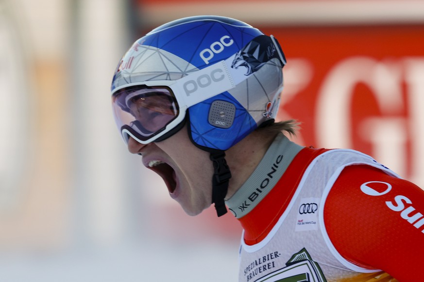 Switzerland&#039;s Marco Odermatt celebrates at the finish area of an alpine ski, men&#039;s World Cup downhill, in Val Gardena, Italy, Saturday, Dec. 21, 2024. (AP Photo/Alessandro Trovati)