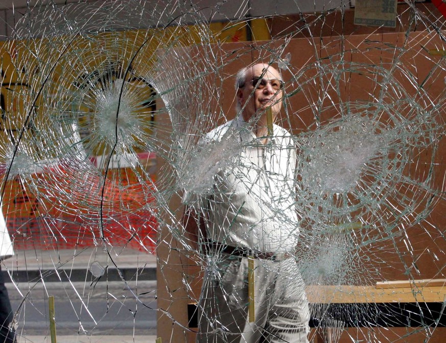 An unidentified Swiss elderly man looks at the damaged leather goods shop widow that was smashed last night, Sunday 01 June 2003, by anti-G8 protesters, in Geneve. Hundreds of anti globalisation prote ...