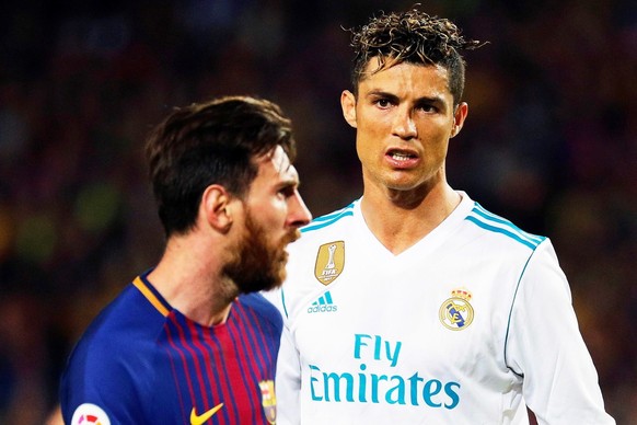 epa06715822 FC Barcelona&#039;s striker Lionel Messi (L) and Real Madrid&#039;s striker Cristiano Ronaldo (R) react during the Spanish Primera Division soccer match between FC Barcelona and Real Madri ...