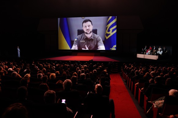 epa09953398 Ukraine&#039;s President Volodymyr Zelensky appears on a screen during the Opening Ceremony of the 75th annual Cannes Film Festival, in Cannes, France, 17 May 2022. The festival runs from  ...