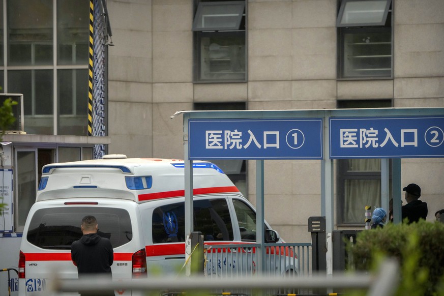 An ambulance drives through an entrance of the Beijing Changfeng Hospital in Beijing, Thursday, April 20, 2023. The death toll from a fire at a Beijing hospital rose to more than two dozen, most of th ...