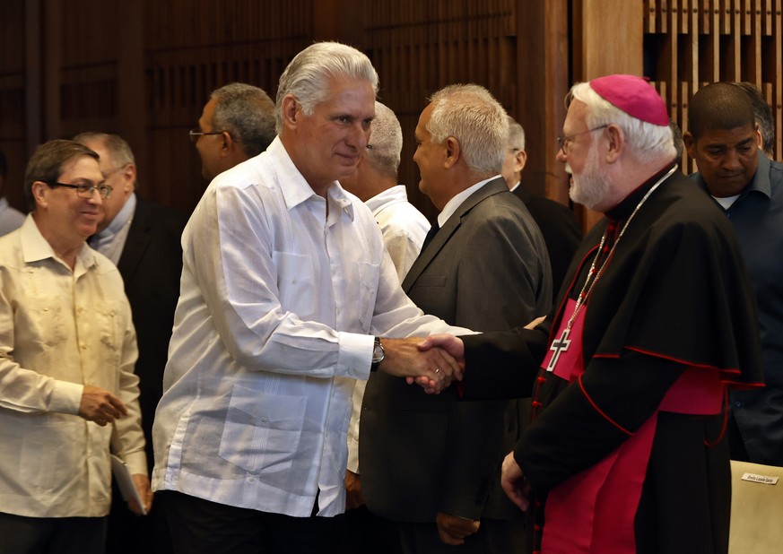 epa12159123 Cuban President Miguel Diaz-Canel (L) greets the Vatican Secretary for Relations with States and International Organizations, Paul Richard Gallagher, during the central act for the 90th an ...
