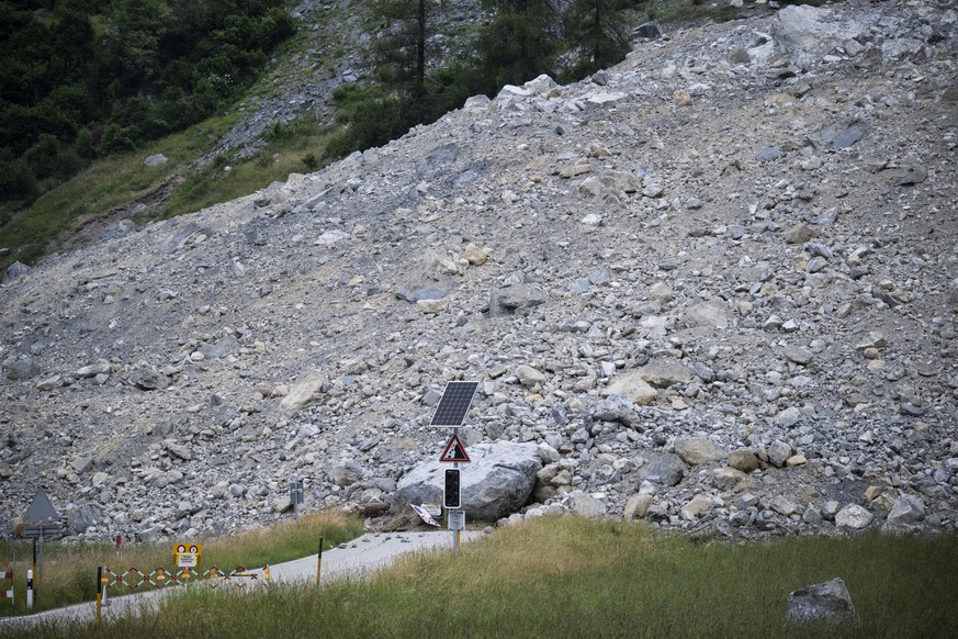 epa10715271 Media people inspect the debris flow during a media tour, in Brienz-Brinzauls, Switzerland, 28 June 2023. On 15 June, a stream of debris nearly reached the village, which had been evacuate ...
