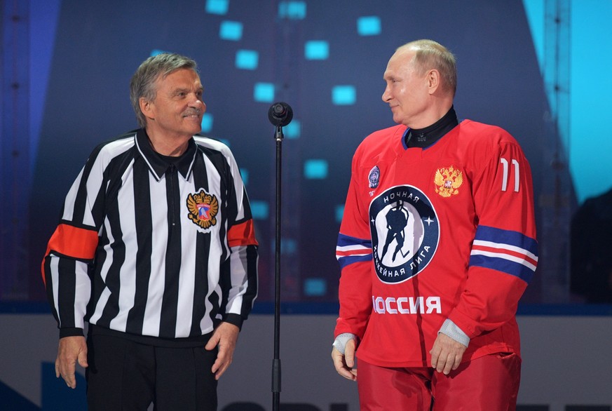 epa09189646 Russian President Vladimir Putin (R) and IIHF (International Ice Hockey Federation) President Rene Fasel (L) take part in a gala match with the participation of Russian hockey legends as p ...