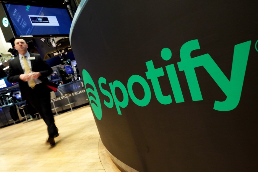 FILE - A trading post sports the Spotify logo on the floor of the New York Stock Exchange, Tuesday, April 3, 2018. Spotify said Monday, Dec. 4, 2023 it&#039;s axing 17% of its global workforce, in the ...