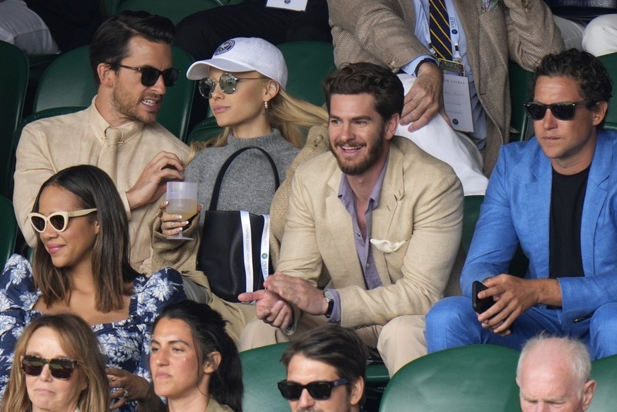 CAPTION CORRECTS SPELLING Actor Andrew Garfield, second right, and singer Ariana Grande, second left, sit in the stands on Centre Court for the final of the men&#039;s singles between Spain&#039;s Car ...