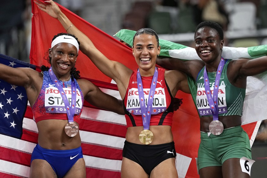 Bronze medalist United States&#039; Grace Stark, gold medalist Switzerland&#039;s Ditaji Kambundji and silver medalist Nigeria&#039;s Tobi Amusan, from left, pose after the women&#039;s 100 meters hur ...