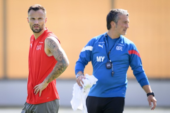 Switzerland&#039;s forward Haris Seferovic, left, and Switzerland&#039;s head coach Murat Yakin, right, attend a open training session of Swiss national soccer team in preparation for the FIFA World C ...
