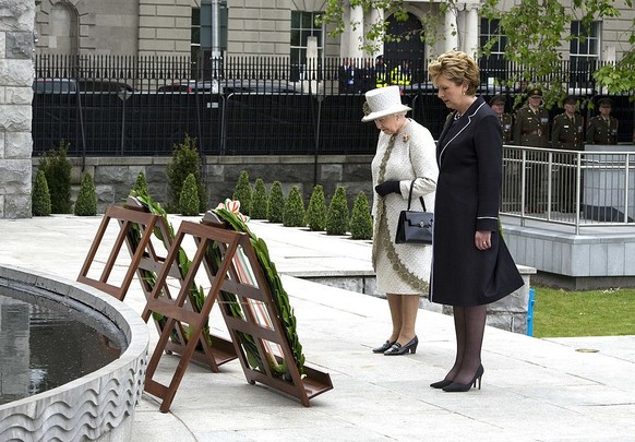 DUBLIN, IRELAND - MAY 17: Irish President Mary McAleese and Queen Elizabeth II lay a wreath at Dublin Memorial Garden on May 17, 2011 in Dublin, Ireland. The Duke and Queen&#039;s visit is the first b ...